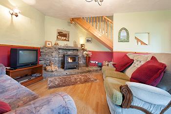 The comfortable sitting area with TV and solid fuel stove